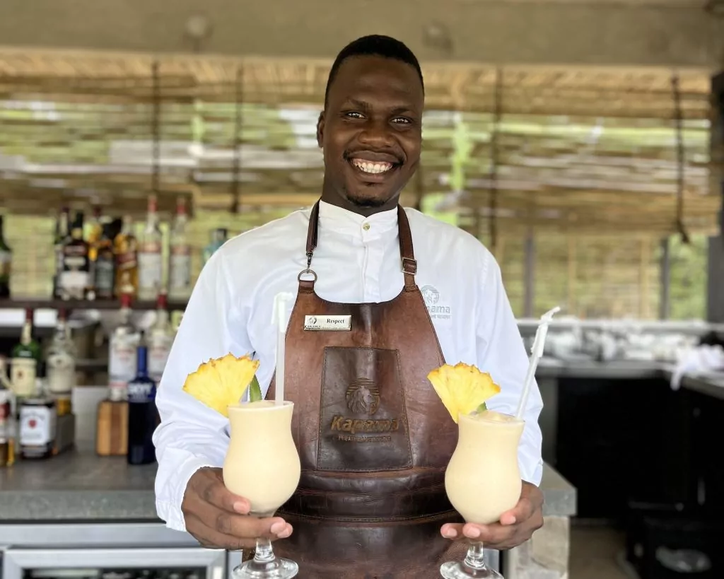 barman at lodge holding cocktails